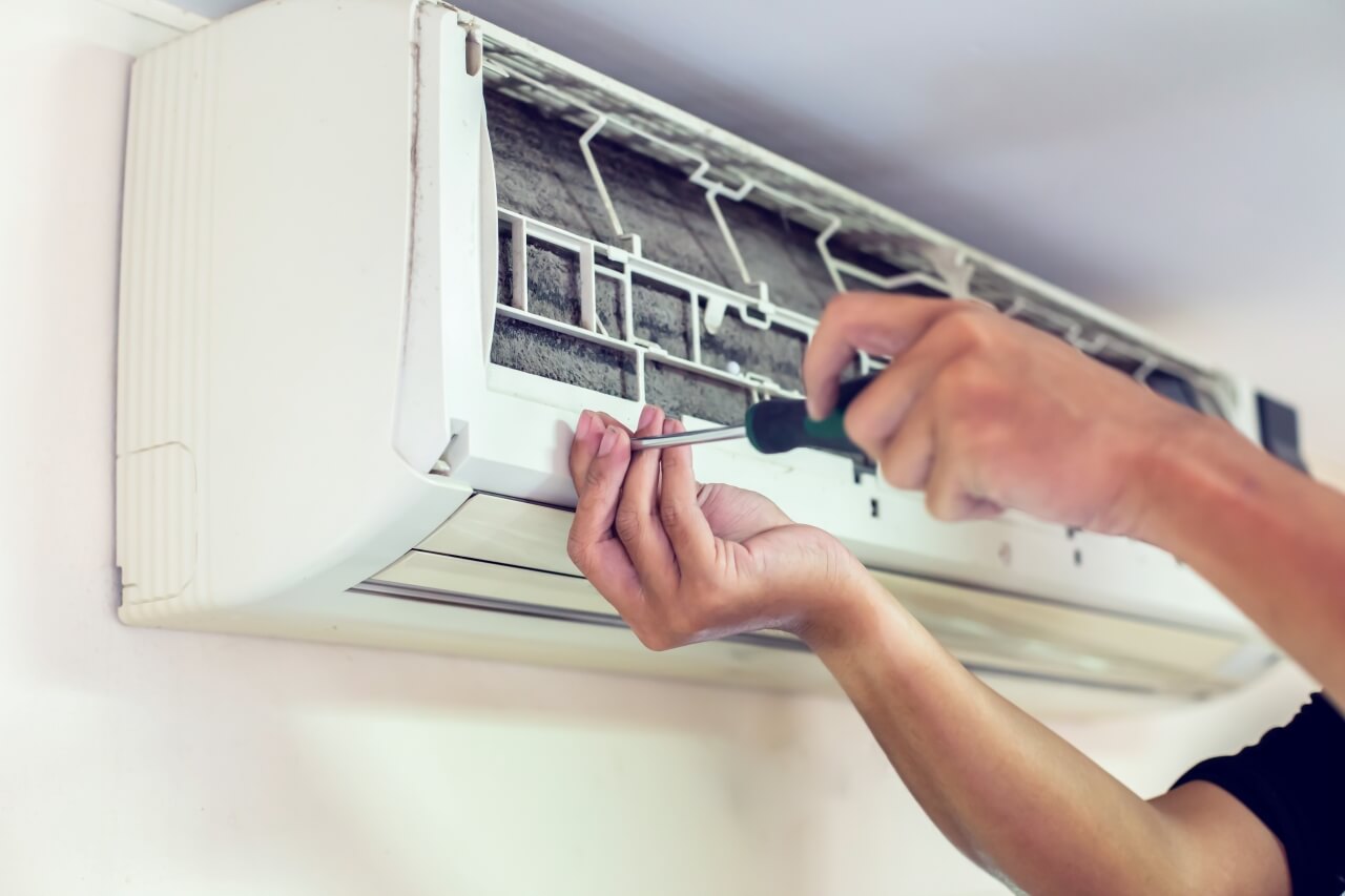 cropped-hands-man-Checking-AC